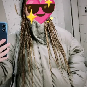 Braids on a woman in a winter coat with a star face