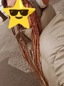 Braids on a winter in a winter coat with a star face